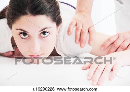 Stock Photograph - Woman having shoulder massage in spa. Fotosearch
