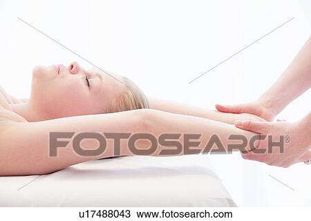 Stock Image - Woman having wrist massage in spa. Fotosearch
