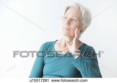 Stock Image - Woman holding chin in hands. Fotosearch