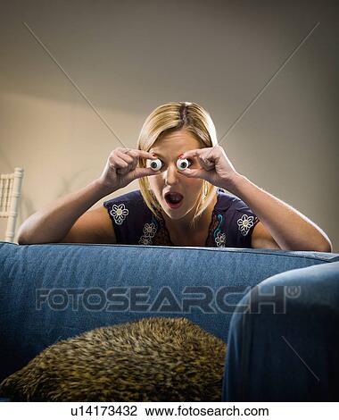 Woman holding glass eyes in living room View Large Photo Image Stock Image - Woman holding glass eyes in living room. Fotosearch