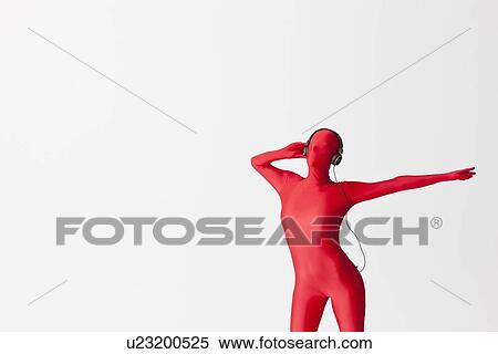 Stock Photography - Woman in bodysuit wearing headphones. Fotosearch