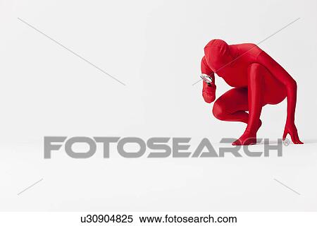 Stock Photography - Woman in bodysuit with magnifying glass. Fotosearch