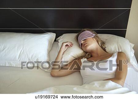 Woman in face mask sleeping in bed View Large Photo Image Picture - Woman in face mask sleeping in bed. Fotosearch