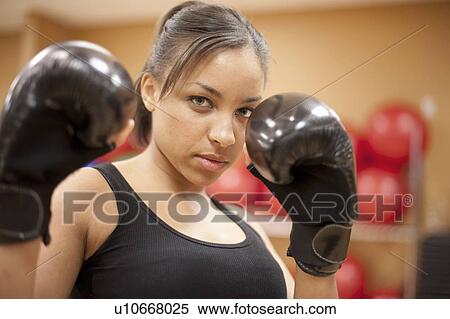 Woman kick boxing in gym View Large Photo Image Stock Photography - Woman kick boxing in gym. Fotosearch