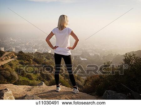 Woman overlooking view from hilltop View Large Photo Image Stock Image - Woman overlooking view from hilltop. Fotosearch