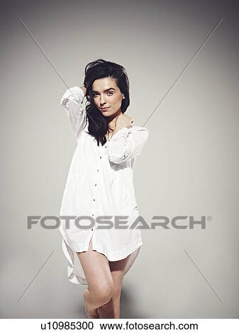 Woman posing in oversized shirt View Large Photo Image Stock Image - Woman posing in oversized shirt. Fotosearch