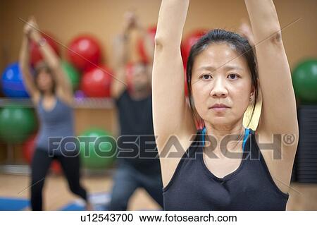 Woman practicing yoga in studio View Large Photo Image Stock Image - Woman practicing yoga in studio. Fotosearch