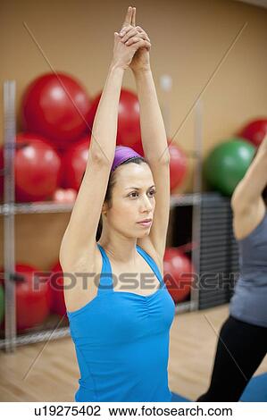 Woman practicing yoga in studio View Large Photo Image Stock Image - Woman practicing yoga in studio. Fotosearch