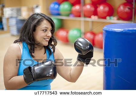 Woman punching bag in gym View Large Photo Image Stock Image - Woman punching bag in gym. Fotosearch
