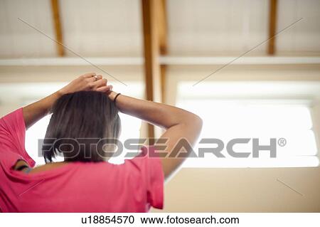 Woman resting hands on her head View Large Photo Image Stock Image - Woman resting hands on her head. Fotosearch