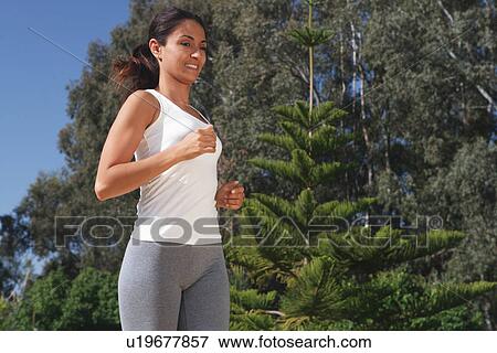 Woman running in park View Large Photo Image Stock Photo - Woman running in park. Fotosearch