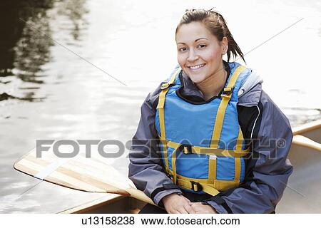 Stock Photo - Woman sitting in canoe. Fotosearch