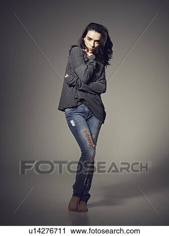 Stock Image - Woman standing with arms crossed. Fotosearch