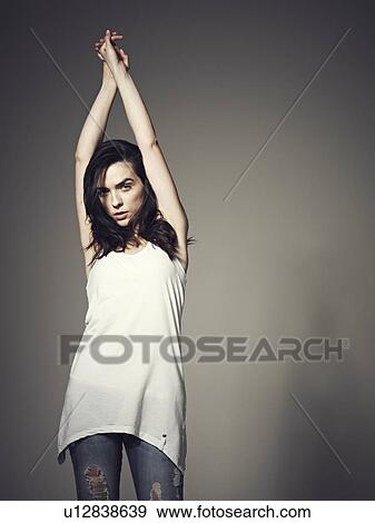 Woman stretching arms over head View Large Photo Image Stock Photo - Woman stretching arms over head. Fotosearch