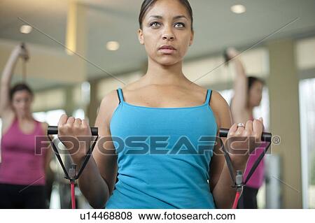 Woman stretching in gym View Large Photo Image Stock Photo - Woman stretching in gym. Fotosearch