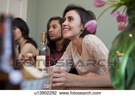 Woman talking at dinner table View Large Photo Image Stock Image - Woman talking at dinner table. Fotosearch