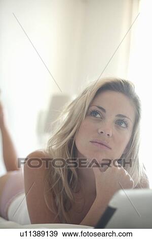 Woman using tablet computer in bed View Large Photo Image Stock Photo - Woman using tablet computer in bed. Fotosearch