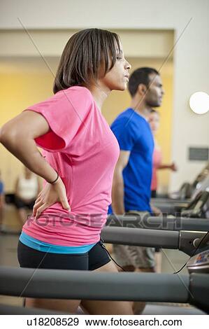 Woman using treadmill in gym View Large Photo Image Stock Photo - Woman using treadmill in gym. Fotosearch