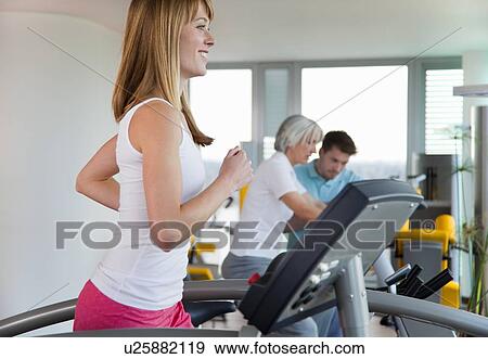 Woman using treadmill in gym View Large Photo Image Stock Photo - Woman using treadmill in gym. Fotosearch