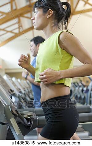 Woman using treadmill in gym View Large Photo Image Stock Photography - Woman using treadmill in gym. Fotosearch