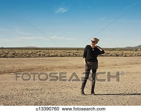 Woman walking in dry field, on the road from Los Angeles to Las Vegas View Large Photo Image Stock Image - Woman walking in dry field, on the road from Los Angeles to Las Vegas. Fotosearch