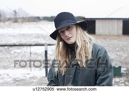 Stock Photography - Woman walking in snowy yard. Fotosearch