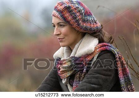 Woman wearing knitted hat and scarf View Large Photo Image Stock Image - Woman wearing knitted hat and scarf. Fotosearch