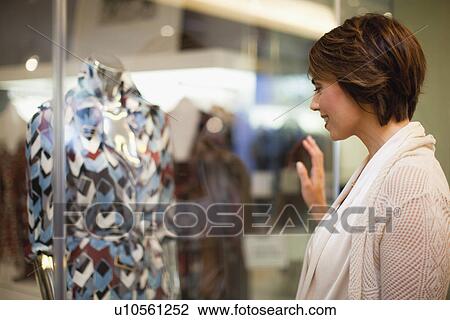 Woman window shopping on city street View Large Photo Image Stock Image - Woman window shopping on city street. Fotosearch