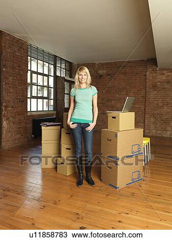 Woman with cardboard boxes in new home View Large Photo Image Stock Image - Woman with cardboard boxes in new home. Fotosearch