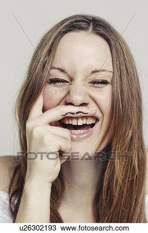 Stock Image - Woman with finger mustache. Fotosearch