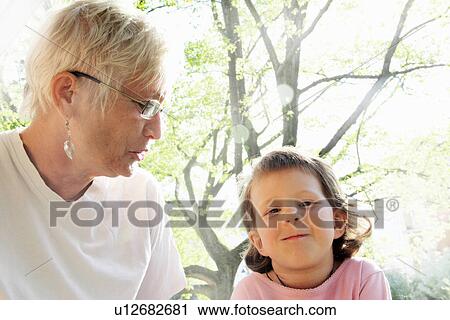 Stock Image - Woman with granddaughter outdoors. Fotosearch
