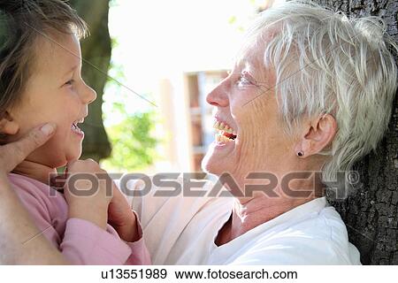 Woman with granddaughter outdoors View Large Photo Image Stock Photo - Woman with granddaughter outdoors. Fotosearch