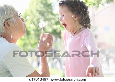 Stock Photo - Woman with granddaughter outdoors. Fotosearch