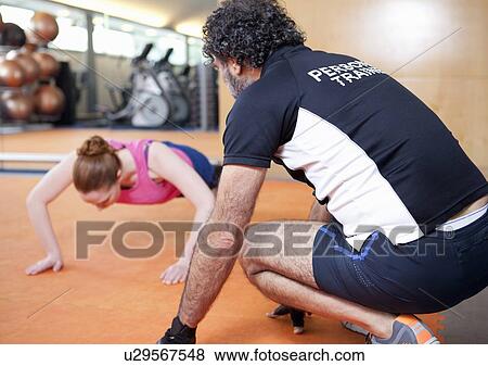 Woman working with trainer in gym View Large Photo Image Stock Photo - Woman working with trainer in gym. Fotosearch