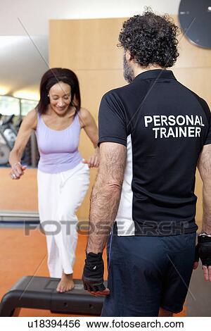 Woman working with trainer in gym View Large Photo Image Stock Photograph - Woman working with trainer in gym. Fotosearch