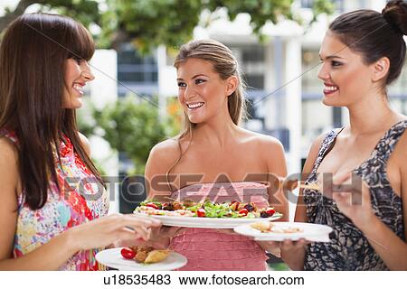 Stock Image - Women eating hors doeurves together. Fotosearch