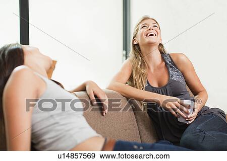 Women having coffee together on sofa View Large Photo Image Stock Photo - Women having coffee together on sofa. Fotosearch