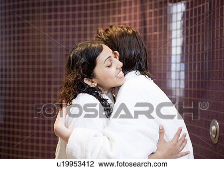 Women in bathrobes hugging in shower View Large Photo Image Stock Image - Women in bathrobes hugging in shower. Fotosearch
