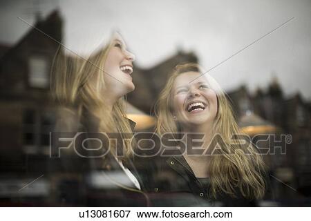 Women laughing at window View Large Photo Image Stock Photo - Women laughing at window. Fotosearch