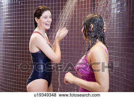 Stock Photo - Women showering in swimsuits. Fotosearch