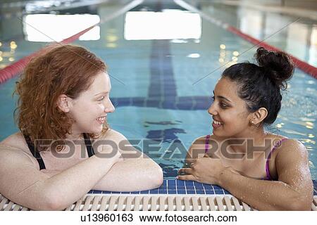 Women talking in indoor pool View Large Photo Image Stock Image - Women talking in indoor pool. Fotosearch