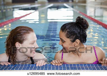 Women talking in indoor pool View Large Photo Image Stock Photography - Women talking in indoor pool. Fotosearch