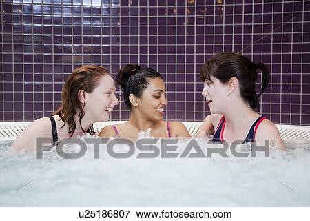 Stock Photo - Women talking in jacuzzi. Fotosearch
