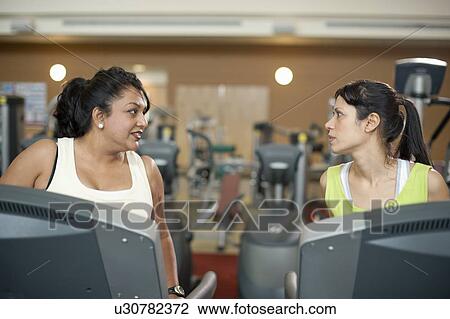 Women using treadmills in gym View Large Photo Image Stock Image - Women using treadmills in gym. Fotosearch