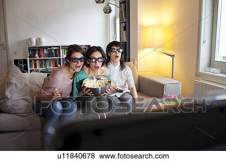 Stock Photo - Women watching 3D movie together. Fotosearch