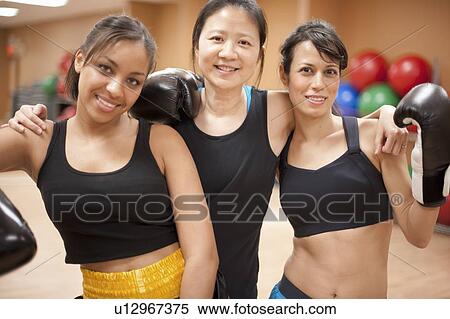 Women with boxing gloves in gym View Large Photo Image Stock Photography - Women with boxing gloves in gym. Fotosearch
