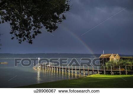 Wooden pier stretching into still water View Large Photo Image Stock Photo - Wooden pier stretching into still water. Fotosearch