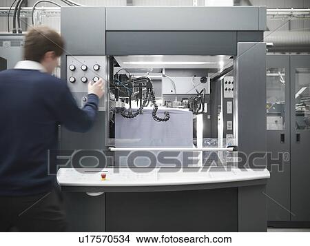 Worker adjusting printing press View Large Photo Image Picture - Worker adjusting printing press. Fotosearch
