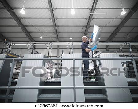 Worker changing plates on printing press View Large Photo Image Stock Image - Worker changing plates on printing press. Fotosearch