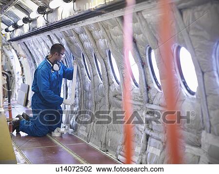 Worker measuring airplane window View Large Photo Image Stock Image - Worker measuring airplane window. Fotosearch